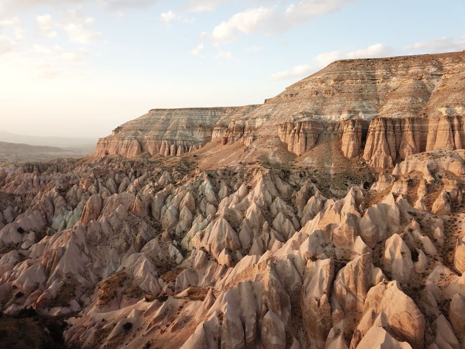 Warm late-afternoon light on the red cliffs and fluted rocks of Red Valley